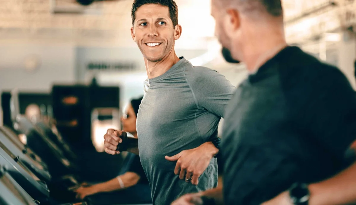 two men running on treadmills