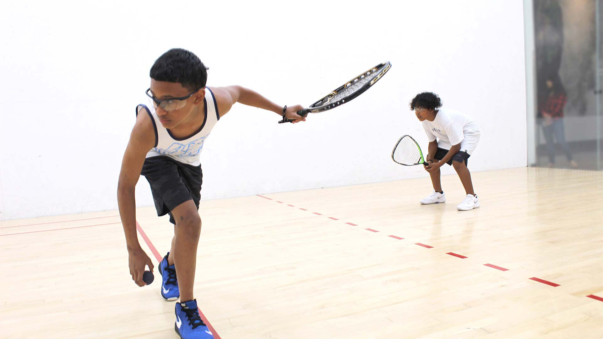 two teenagers playing racquetball