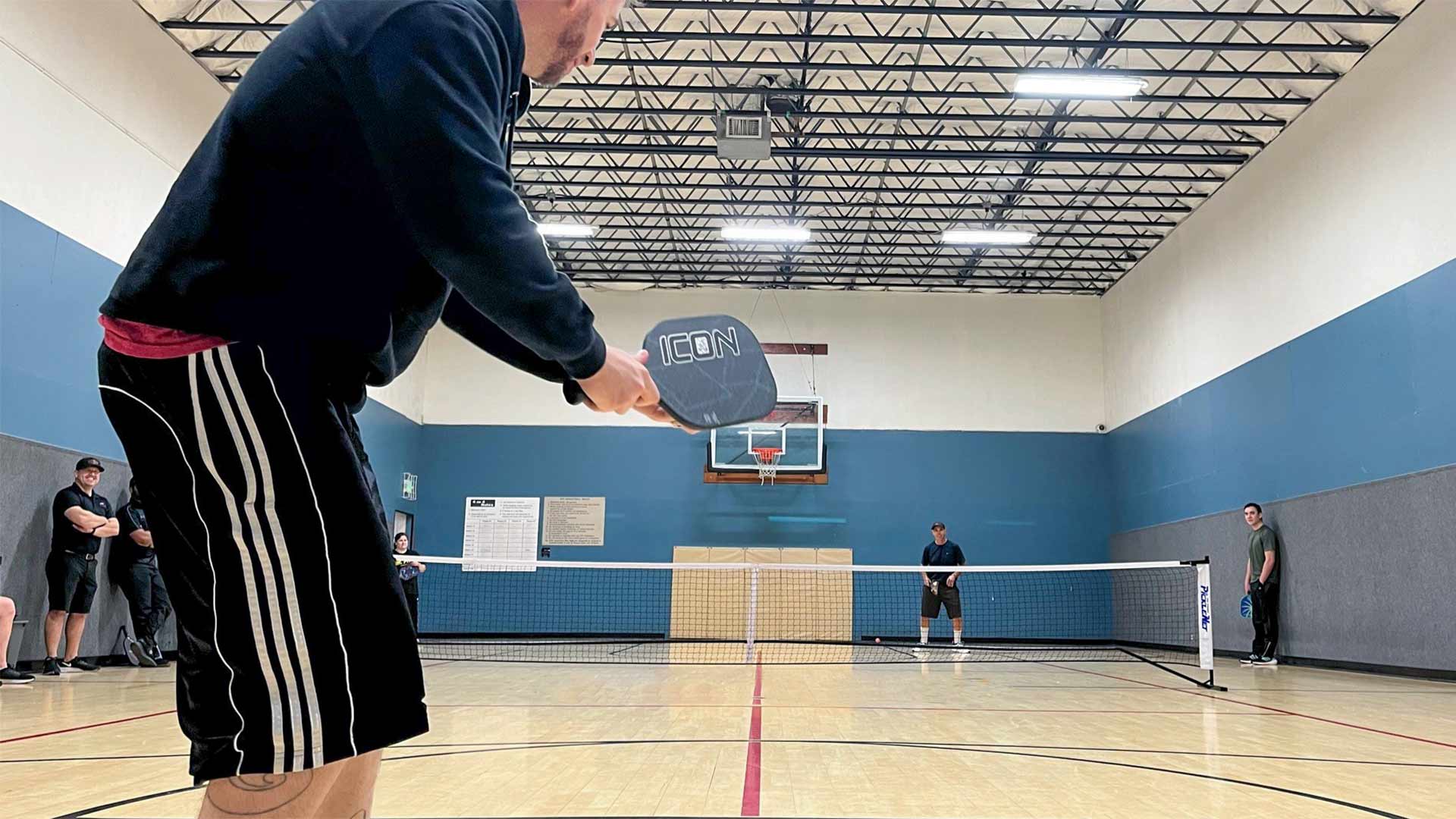 man playing pickleball outdoors